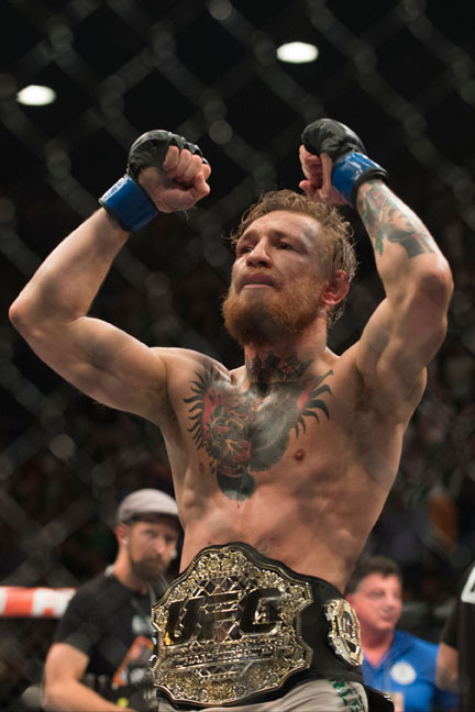 Conor McGregor celebrates after defeating Chad Mendes for the interim UFC featherweight title during UFC 189 at the MGM Grand Garden Arena in Las Vegas, Nevada on July 11, 2015. (Cooper Neill)