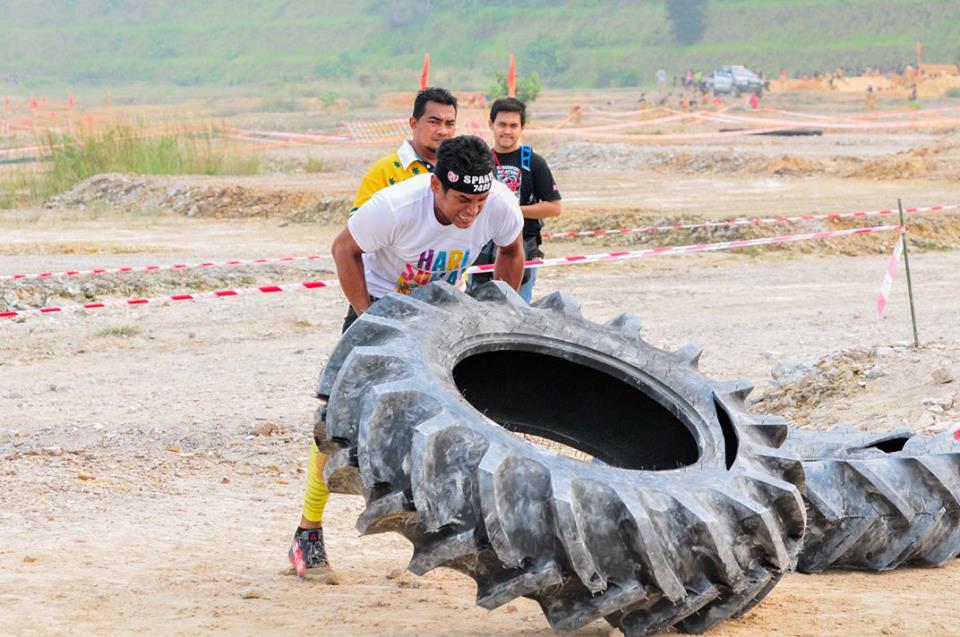 Youth and Sports Minister Khairy Jamaludin flipping tyres to get through the Spartan Race Malaysia. Photo from Spartan Race MY