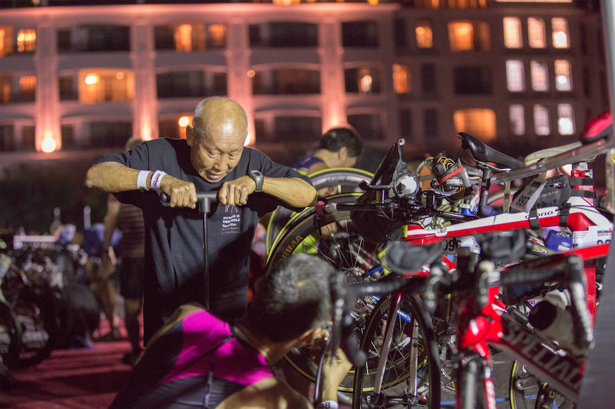 Eldest Malaysian IRONMAN Yee Sze Mun prepares his bike before the race flag off.jpg