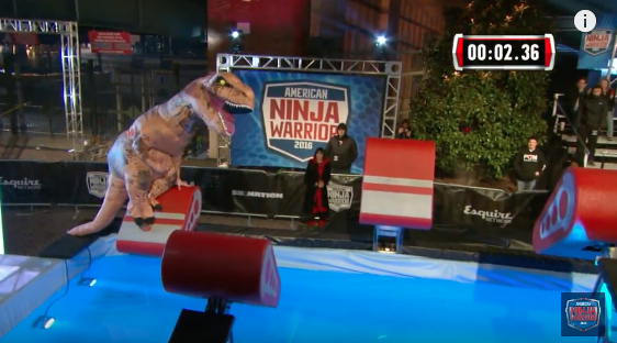 T-Rex roaring and eating up the American Ninja Warrior course. Image from video