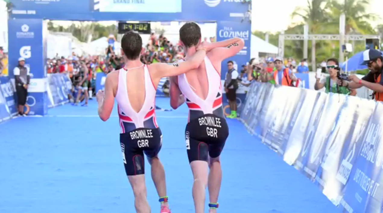 Alistair Brownlee right) helps younger brother Jonny cross the finish line at ITU World Series in Mexico. Image from video)